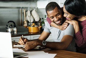 Couple hugging in kitchen