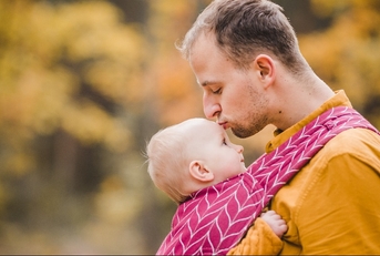Father and a baby in a baby carrier picture