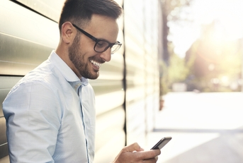 Smiling man looking at phone