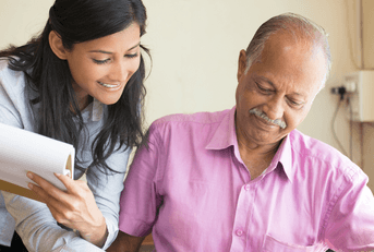 Man and woman talking and looking at paperwork