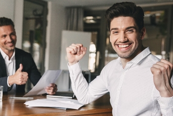 successful man rejoicing and clenching fists 