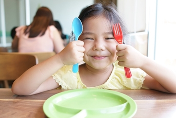  kid girl holding colorful spoon and fork 