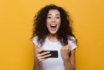 Happy woman holding cellphone