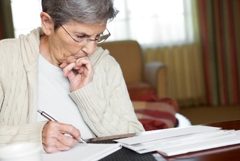 senior woman working on her bills