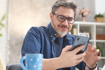 Mature man looking at phone