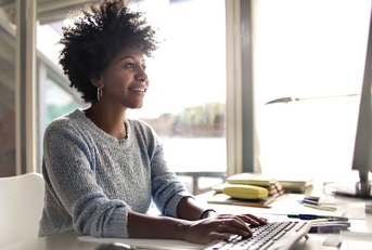 young woman working on computer at home