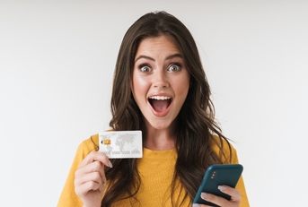 Happy woman holding credit card