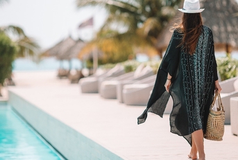 woman walking by the pool in a luxury hotel resort