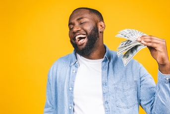 african american man in casual t-shirt holding money dollar bills