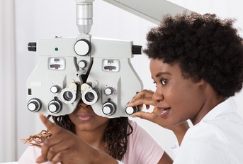optometrist doing sight testing for patient
