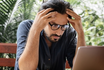 man stressed on laptop