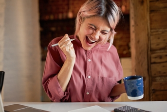 woman who is happy about figuring out her finances