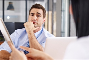 skeptical interviewer looking at interviewee