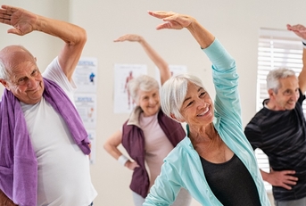Senior people stretching at gym