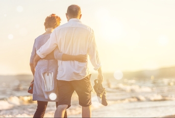 elderly couple hugging on seacoast
