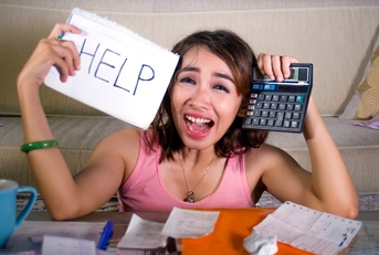 worried woman calculating monthly expenses and debt