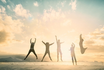 group of people jumping for good life on weekend