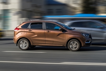 brown car Lada Xray riding at the city street