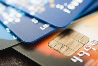 A stack of multicolored credit cards.