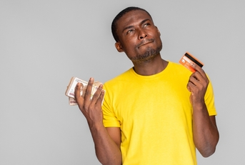 Man holding credit cards in each hand