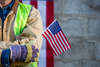 Worker holding American flag