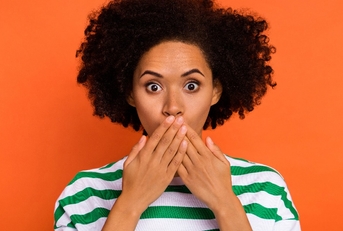 attractive puzzled wavy-haired girl closing mouth oops 