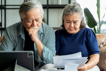 asian senior couple checking and calculate financial billing together