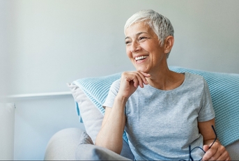 mature woman relaxing on her couch at home in the sitting room