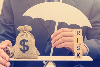 businessman holds a white umbrella protects a dollar bag on basic balance scale