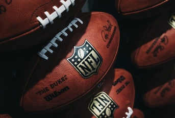 Rows of NFL footballs