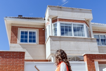 woman inspector checking house at construction site