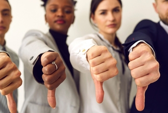 disappointed young multiethnic people give thumbs down