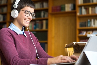 Girl with headphones smile and type