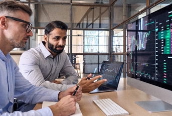 stock exchange market investors discussing trading charts