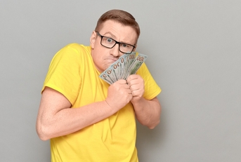  greedy man holding money in hands