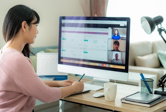 woman talking to her colleagues about plan in video conference