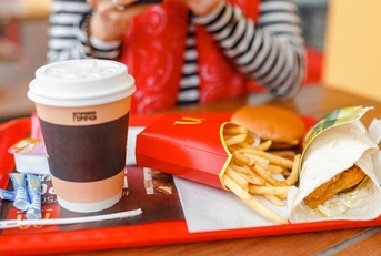 hamburger drink and fries on a tray in McDonald fast food restaurant