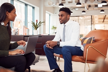 businesswoman interviewing male job candidate