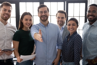 male leader stretch out his hand for handshake welcoming new employee