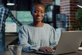 adult woman using a laptop on a desk