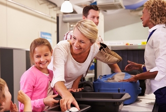 family at airport passing through security check