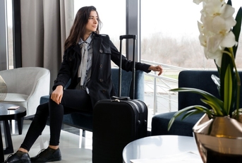 a woman waiting in an airport lounge for her flight