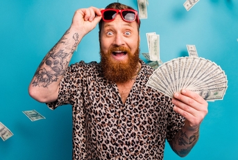 man with tattoo holds fan of money