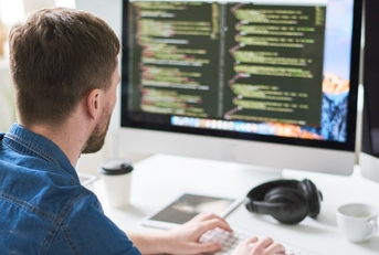 contemporary web developer writing code for program