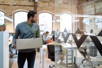 employee holding a box of personal belongings after leaving