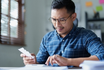 male SME business owner with a stressed and anxious face 