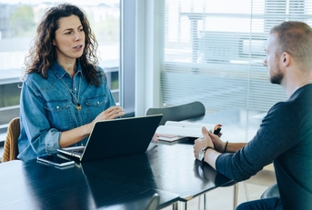 female employee talking with male colleague