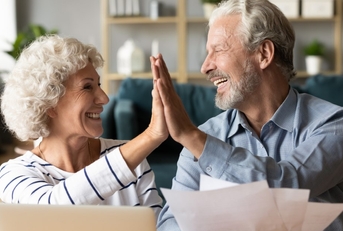 elderly couple giving high five