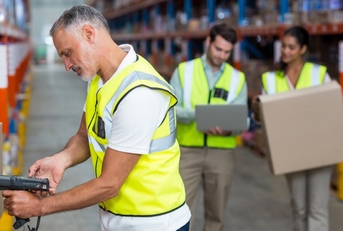 worker scanning boxes in a warehouse