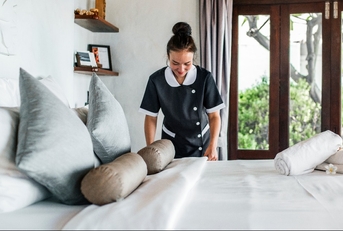 housekeeper cleaning a hotel room